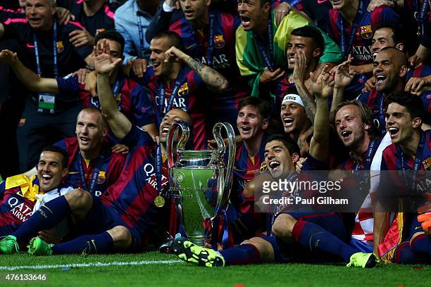 Barcelona players including Javier Mascherano, Lionel Messi, Neymar and Luis Suarez celebrate victory with the trophy after the UEFA Champions League...