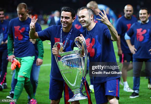 Xavi Hernandez and Andres Iniesta of Barcelona celebrate with the trophy after the UEFA Champions League Final between Juventus and FC Barcelona at...