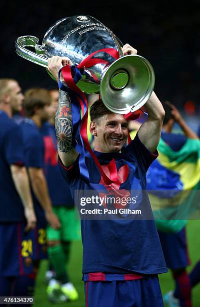 Lionel Messi of Barcelona celebrates with the trophy after the UEFA Champions League Final between Juventus and FC Barcelona at Olympiastadion on...