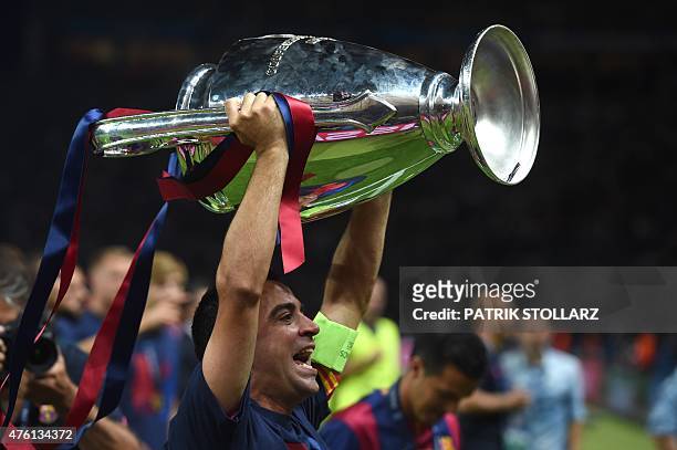 Barcelona's midfielder Xavi Hernandez celebrates with the trophy after the UEFA Champions League Final football match between Juventus and FC...