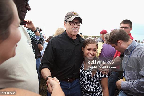 Republican presidential hopeful and former Texas Governor Rick Perry greets guests at a Roast and Ride event hosted by freshman Senator Joni Ernst on...