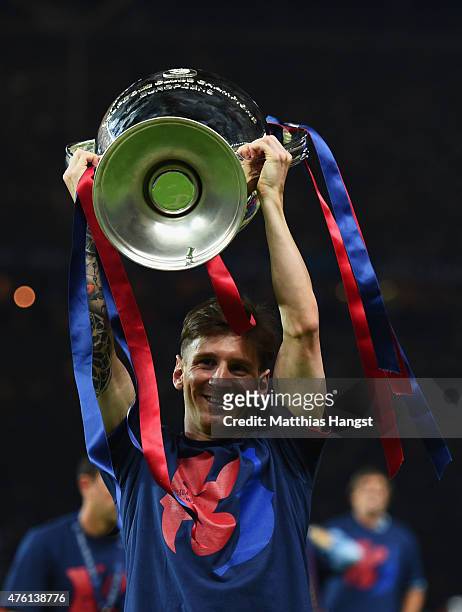 Lionel Messi of Barcelona celebrates with the trophy after the UEFA Champions League Final between Juventus and FC Barcelona at Olympiastadion on...