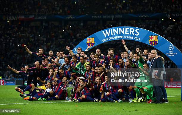 The Barcelona team celebrate victory with the trophy after the UEFA Champions League Final between Juventus and FC Barcelona at Olympiastadion on...