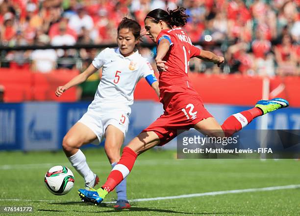 Christine Sinclair of Canada looks to take a shot, as Haiyan Wu of China PR looks on during the FIFA Women's World Cup 2015 Group A match between...