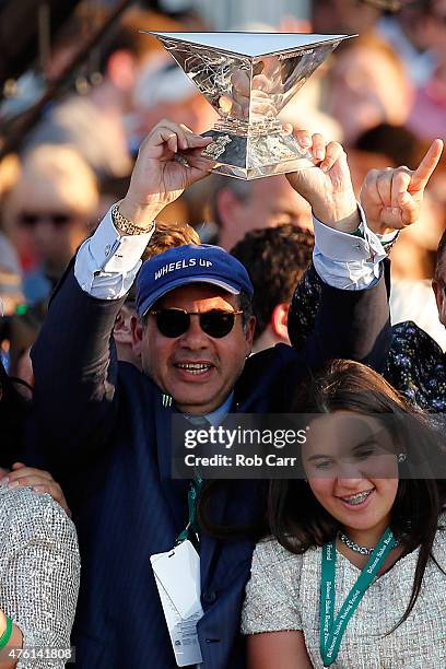 Ahmed Zayat, owner of American Pharoah, celebrates with the Triple Crown Trophy after winning the 147th running of the Belmont Stakes at Belmont Park...