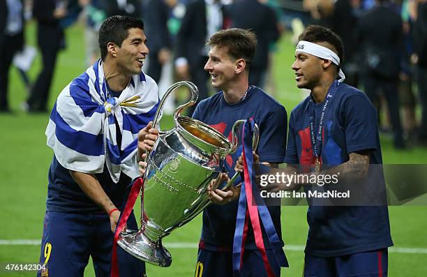 Luis Suarez, Lionel Messi and Neymar of Barcelona holds the trophy during the UEFA Champions League Final between Barcelona and Juventus at...