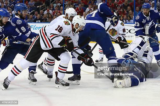 Ben Bishop of the Tampa Bay Lightning makes a save against Marcus Kruger of the Chicago Blackhawks during the first period in Game Two of the 2015...