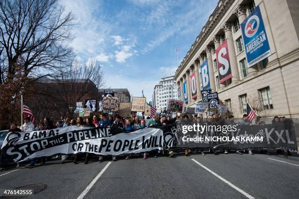 Students protesting against the proposed Keystone XL pipeline march past the US Chamber f Commerce near the White House in Washington,DC on March 2,...