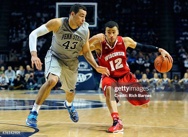 Traevon Jackson of the Wisconsin Badgers drives to the basket against the defense of Ross Travis of the Penn State Nittany Lions during the second...