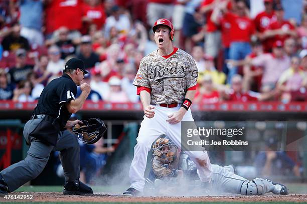 Todd Frazier of the Cincinnati Reds reacts after being thrown out at home plate in the sixth inning of the game against the San Diego Padres at Great...