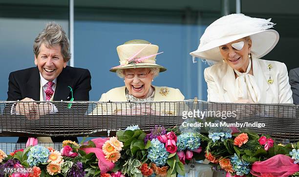 Queen Elizabeth II, her racing manager John Warren and Princess Michael of Kent watch the racing from the balcony of the Royal Box as they attend...