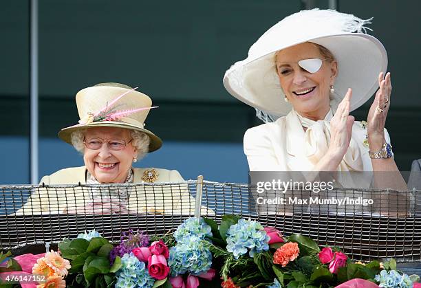 Queen Elizabeth II and Princess Michael of Kent watch the racing from the balcony of the Royal Box as they attend Derby Day during the Investec Derby...