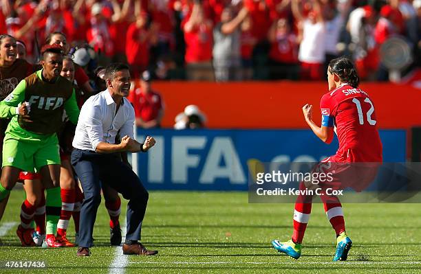 Christine Sinclair of Canada celebrates scoring the go-ahead goal on a penalty kick against China PR as she runs to John Herdman during the FIFA...