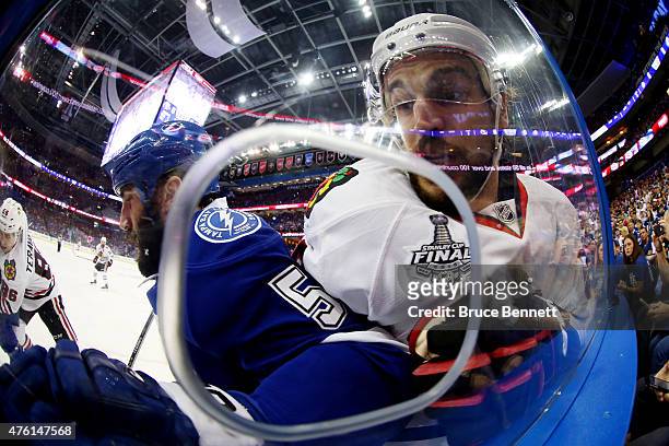 Jason Garrison of the Tampa Bay Lightning checks Antoine Vermette of the Chicago Blackhawks during the first period during Game Two of the 2015 NHL...
