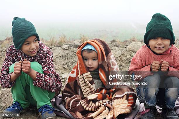 poor children sitting in winter season - girl shivering stock pictures, royalty-free photos & images