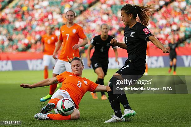 Sherida Spitse of Netherlands slides to save the ball from going out of bounds with pressure from Ali Riley of New Zealand during the FIFA Women's...