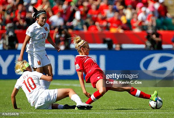 Li Ying of China PR is called for a foul after tackling Lauren Sesselmann of Canada during the FIFA Women's World Cup Canada 2015 Group A match...