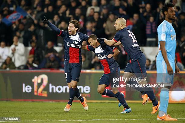 Paris' Brazilian defender Maxwell celebrates with teammates Brazilian defender Alex Costa and Brazilian forward Lucas Moura after scoring a goal...