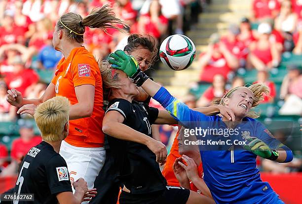 Goalkeeper Loes Geurts of Netherlands defends a corner kick against Hannah Wilkinson and Amber Hearn of New Zealand during the FIFA Women's World Cup...