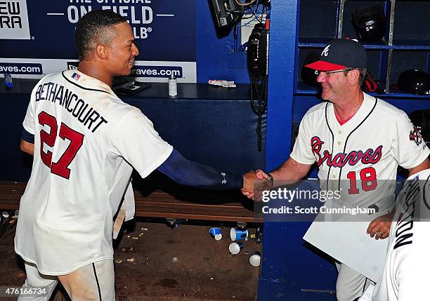 Christian Bethancourt of the Atlanta Braves is congratulated by Bench Coach Carlos Tosca after hitting a walk-off ninth inning solo home run against...