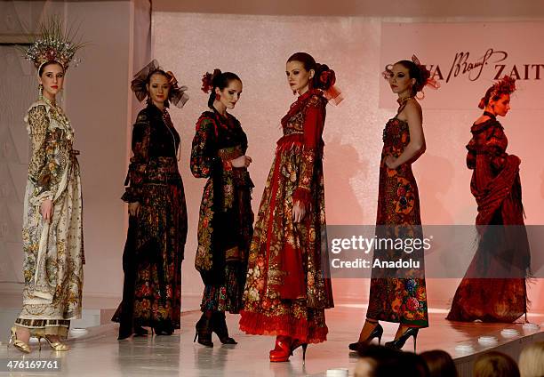 Models present a creation for Slava Zaitsev's ready-to-wear fall/winter 2014-2015 fashion collection in Moscow, Russia on March 2, 2014.