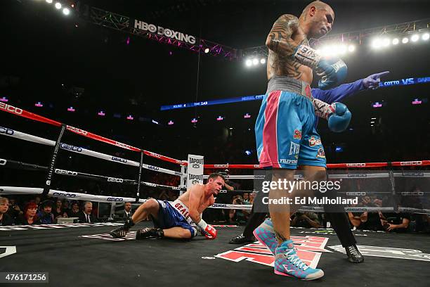 Miguel Cotto walks away after knocking down Daniel Geale during their WBC middleweight world championship fight at the Barclays Center on June 6,...