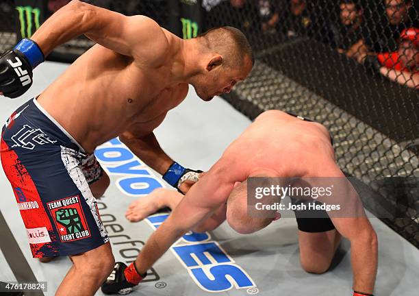 Dan Henderson punches Tim Boetsch in their middleweight bout during the UFC event at the Smoothie King Center on June 6, 2015 in New Orleans,...