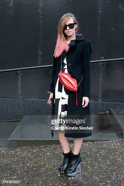 Fashion Designer Nastya Lisansky wears Zara coat, Nastya Lisansky dress, United shoes, Ray Ban sunglasses and Bershka bag on day 5 of London...