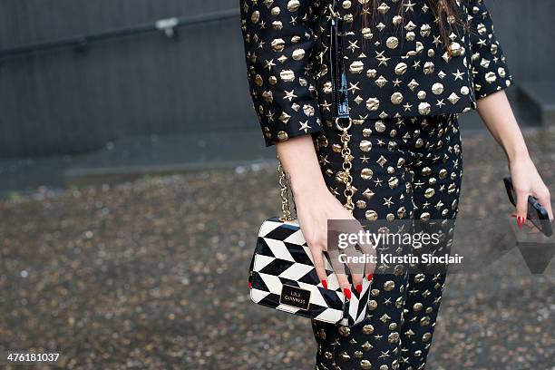 Presenter Zara Martin wears a Moschino top and trousers, LuLu Guinness bag on day 5 of London Collections: Women on February 18, 2014 in London,...