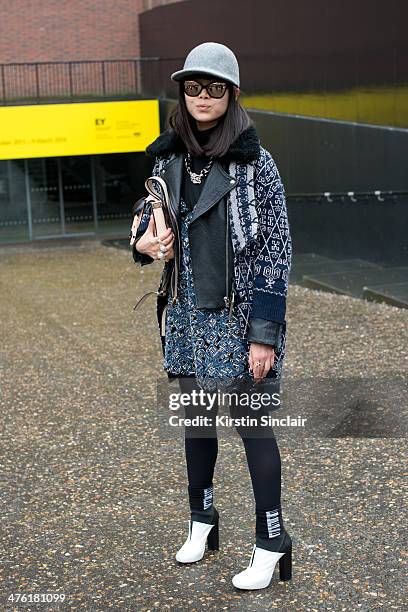 Fashion Editor at Elle China Leaf Greener wears a Stella McCartney hat, Chanel glasses, necklace, top, jacket and shirt, Yadu bag, Charline de Luca...