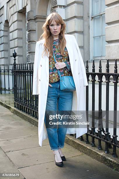 Fashion Blogger Fiona Jane wears a Saint Laurent bag, True Religion jeans, Zara shoes, Won-Hundred top, Versace coat, and Back rings on day 5 of...