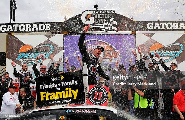 Kevin Harvick, driver of the Jimmy John's Chevrolet, celebrates in Victory Lane after winning the NASCAR Sprint Cup Series The Profit On CNBC 500 at...
