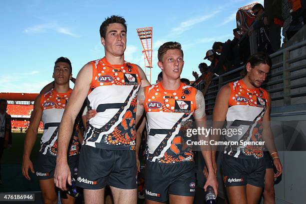 Jeremy Cameron of the Giants and Lachie Whitfield of the Giants walk off the field after winning the round 10 AFL match between the Greater Western...