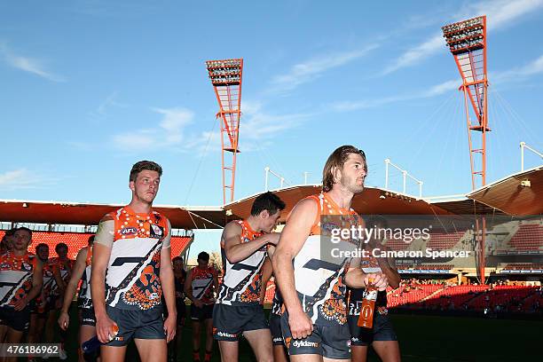 Callan Ward of the Giants and team mates walk off the field after winning the round 10 AFL match between the Greater Western Sydney Giants and the...