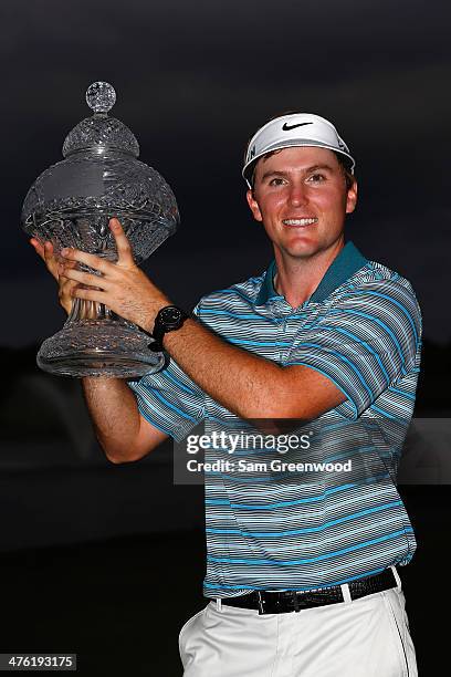 Russell Henley celebrates with the trophy after winning The Honda Classic at PGA National Resort and Spa on March 2, 2014 in Palm Beach Gardens,...