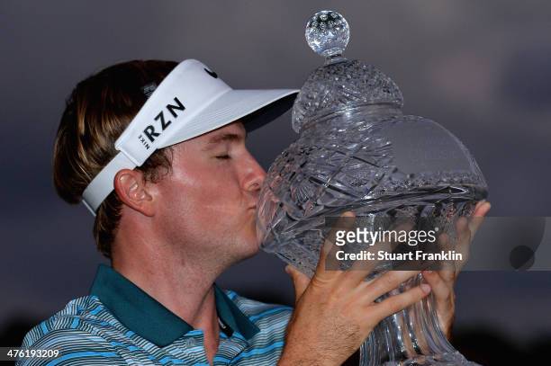 Russell Henley celebrates with the trophy after winning The Honda Classic at PGA National Resort and Spa on March 2, 2014 in Palm Beach Gardens,...