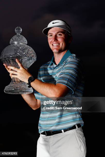 Russell Henley celebrates with the trophy after winning The Honda Classic at PGA National Resort and Spa on March 2, 2014 in Palm Beach Gardens,...