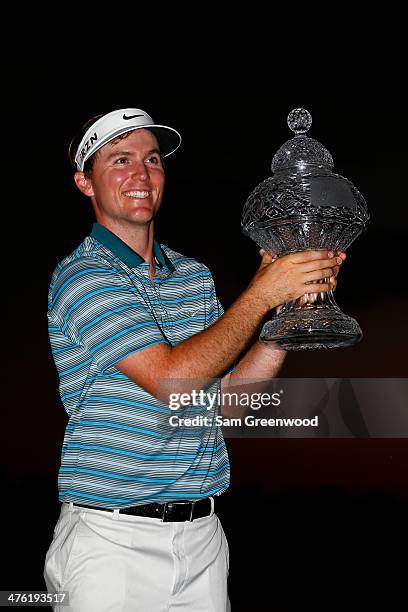 Russell Henley celebrates with the trophy after winning The Honda Classic at PGA National Resort and Spa on March 2, 2014 in Palm Beach Gardens,...