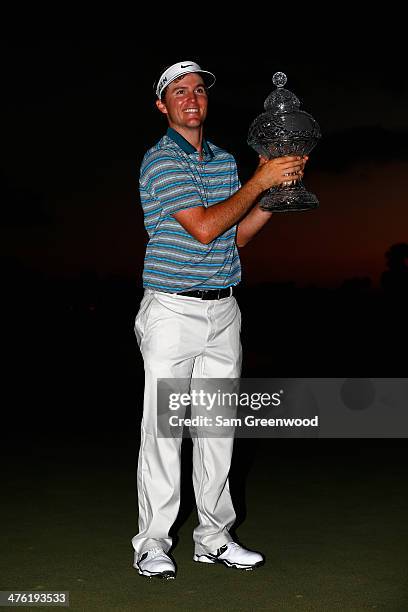 Russell Henley celebrates with the trophy after winning The Honda Classic at PGA National Resort and Spa on March 2, 2014 in Palm Beach Gardens,...