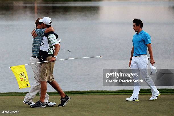 Russell Henley reacts with his caddie after winning a four-way playoff hole to defeat Rory McIlroy of Northern Ireland , Russell Knox, and Ryan...