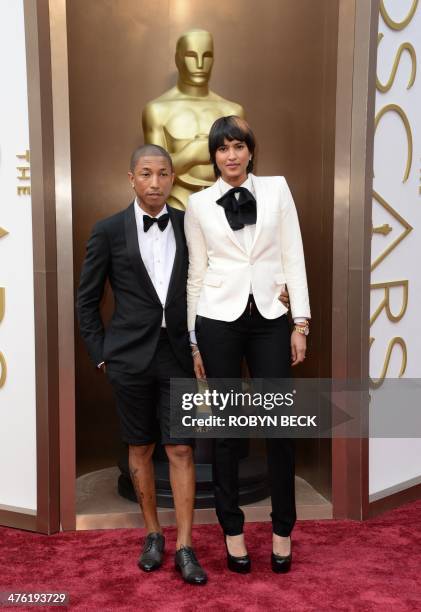 Pharrell Williams and Helen Lasichanh arrive on the red carpet for the 86th Academy Awards on March 2nd, 2014 in Hollywood, California. AFP PHOTO /...