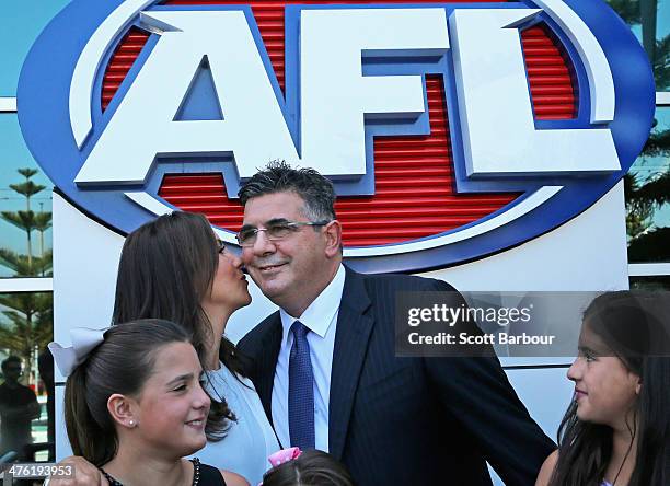 Chief executive Andrew Demetriou is kissed by his wife Symone as his daughters Francesca and Alexandra look on during an AFL press conference at AFL...