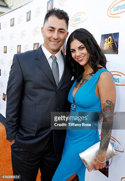 Dennis Desantis and guest attend the Lupus LA's Orange Ball A Night of Superheroes at the Fox Studio lot on June 6, 2015 in Century City, California.