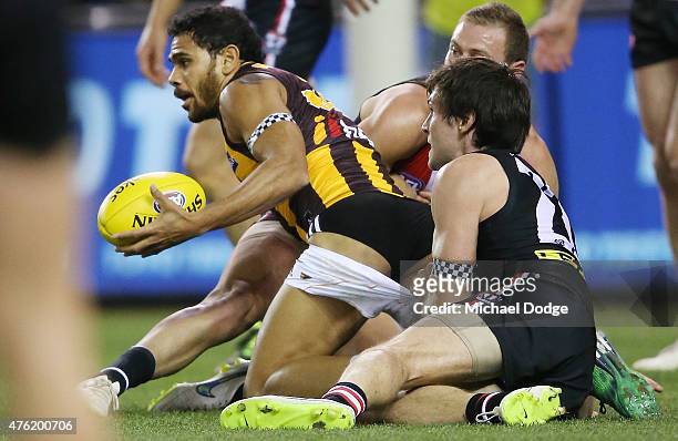 Cyril Rioli of the Hawks has his shorts pulled down in a tackled by Farren Ray of the Saints during the round 10 AFL match between the St Kilda...