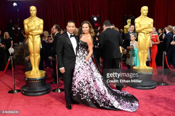 Recording artist John Legend and his wife, model Christine Teigen, attend the Oscars held at Hollywood & Highland Center on March 2, 2014 in...