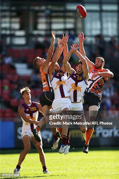Shane Mumford and Adam Treloar of the Giants compete for a mark with Zac O'Brien of the Lions during the round 10 AFL match between the Greater...