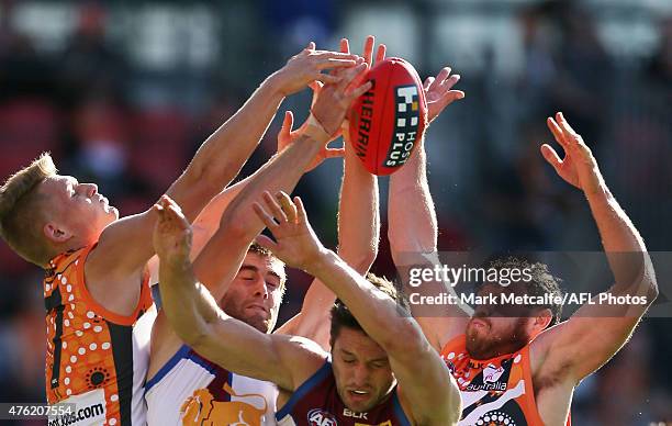 Shane Mumford and Adam Treloar of the Giants compete for a mark with Zac O'Brien of the Lions during the round 10 AFL match between the Greater...