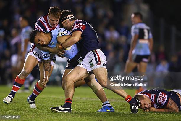 Sosaia Feki of the Sharks is tackled during the round 13 NRL match between the Sharks and the Roosters at Remondis Stadium on June 7, 2015 in Sydney,...