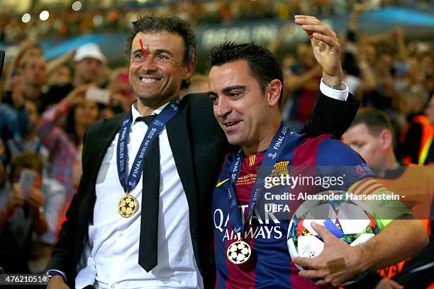 Luis Enrique, head coach of Barcelona celebrates with his player Xavi Hernandez after winning the UEFA Champions League Finale between Juventus Turin...