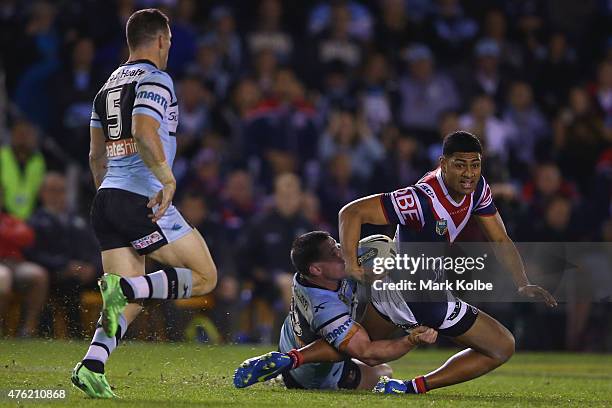 Daniel Tupou of the Roosters is tackled during the round 13 NRL match between the Sharks and the Roosters at Remondis Stadium on June 7, 2015 in...